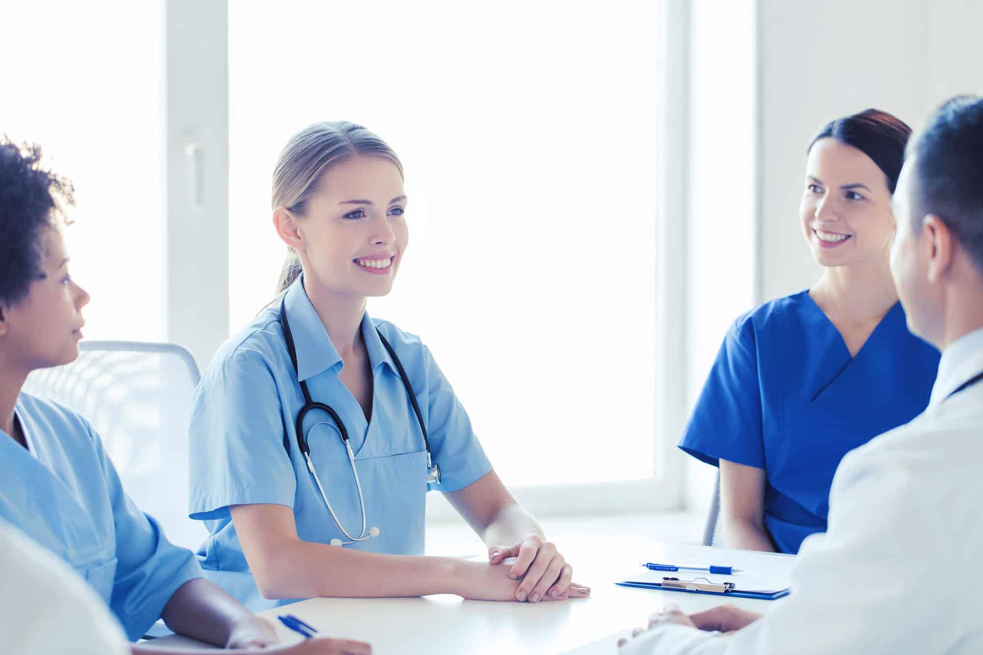 Nurses-stilling-around-table