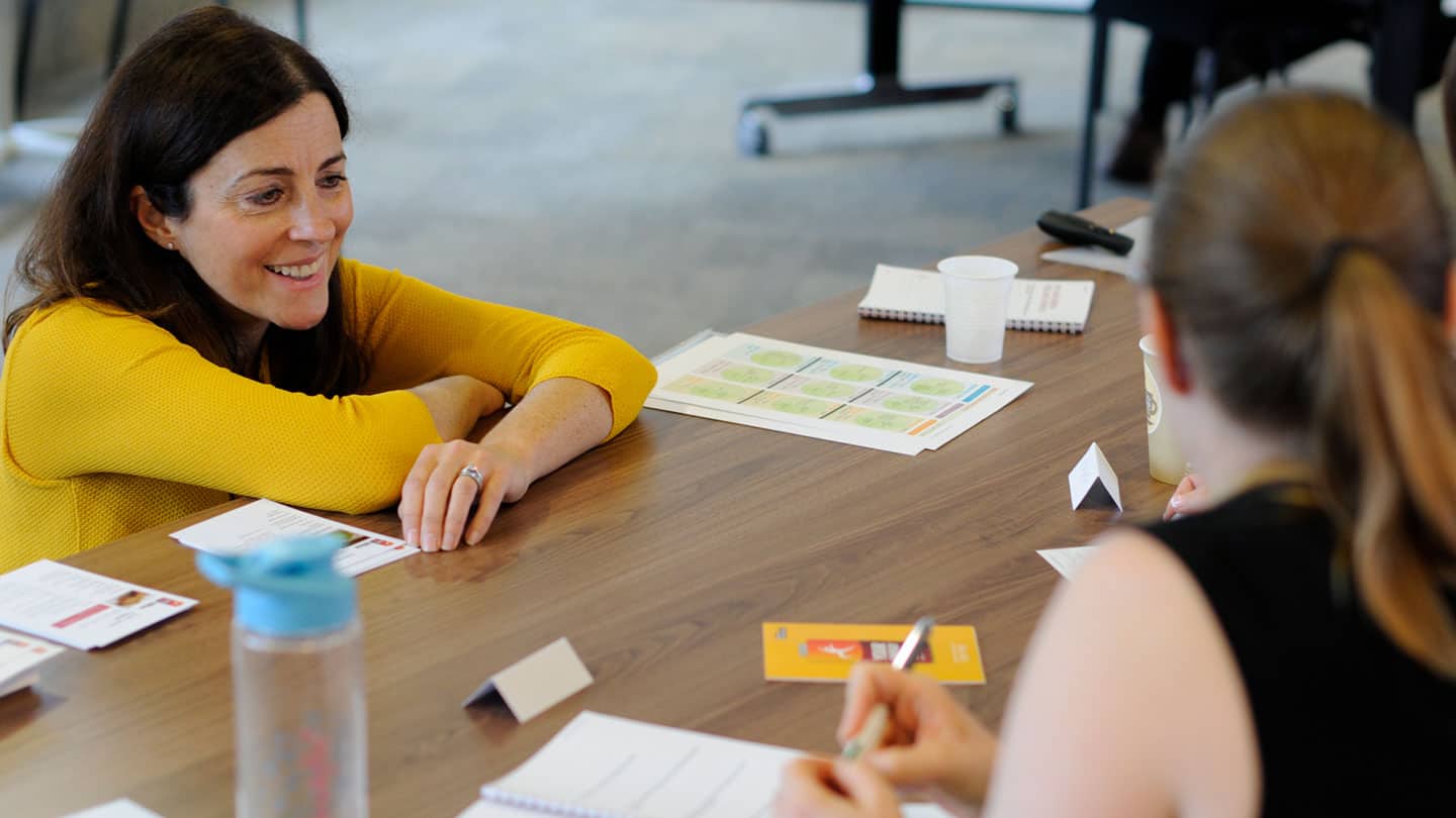 lady listening on table at workshop