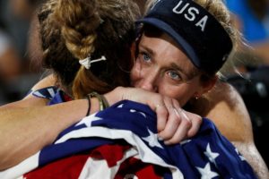 USA Womens Volleyball team celebrate victory at the Olympic Games - showing the the importance of teamwork